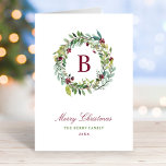 Elegant Winter Greenery Burgundy Monogram Wreath Feiertagskarte<br><div class="desc">Diese elegante und minimale Weihnachtskarte bietet ein Blumenkrautdesign, das ein individuelles Bordeaux-/Weinrot-Monogramm bildet, das mit einem roten, bordeauxroten, grünen und dunkelgrauen Text beginnt, der mit Ihrem "Frohen Weihnachtsgrüßen", einer individuellen Botschaft in der Karte, Ihrem ersten, Nachnamen, Familiennamen und dem Jahr vollständig personalisiert werden kann. Ein korrespondierender bordeauxroter Aquarellhintergrund zieht die...</div>