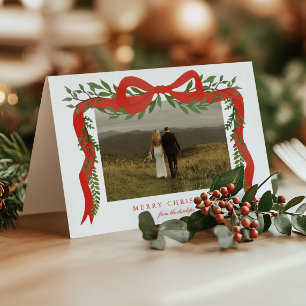 Elegante rote Schleife mit Grünzeug Foto Weihnacht Feiertagskarte
