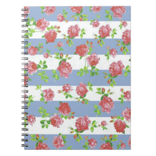 Elegante weibliche rosa Rosen auf blauem u. weiße Notizblock