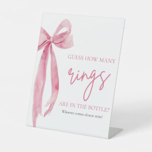 Eleganter Rosa-Bow rät wie viele Rings-Spiel Sockelschild