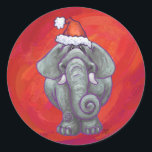 Elephant Christmas on Red Runder Aufkleber<br><div class="desc">Animal Parade Festival Elephant Weihnachtsgeschenke und Accessoires zeigen unser lustiges Kunstwerk eines niedlichen Elefanten, der in einer roten Weihnachtsmannmütze stehend in einer verschneiten Landschaft gegenüber einem von unserem talentierten Kinderbuch-Illustrator Traci Van Wagoner gemalten dunkelblauen Sternenhimmel verziert ist. Auf der Rückseite dieser lustigen Tiergeschenke finden Sie auch unseren skurrilen Elefanten vom...</div>