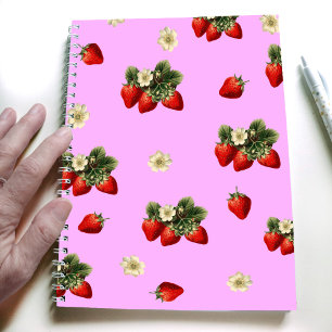 Erdbeerdesign auf einem rosa, modernen Notebook Notizblock