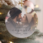 Erste Weihnachten Verlobte Custom Foto Grau Script Keramik Ornament<br><div class="desc">Gedenken Sie Ihre Verlobung mit diesem schönen modernen Sakraldekor. Der kohlegraue Text lautet "Unser erstes Weihnachtsfest verlobt", mit dem Wort "verlobt" in eleganter Schrift, die vor und nach den Wimpern schwebt. Ersetzen Sie das Beispielbild durch Ihr Lieblings-Foto, und fügen Sie Ihre Namen und das Jahr hinzu. Mithilfe eines Farbverlaufsefilters wird...</div>