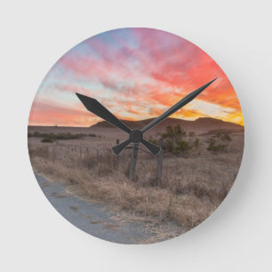 Erster Sonnenuntergang des Tages Runde Wanduhr