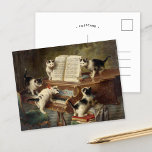 Erwägung der Kätzchen | Carl Reichert Postkarte<br><div class="desc">Erwägung "Kittens" (1908) | Carl Reichert’s The Kittens' Erwägungsgrund ist ein charmantes und fantasievolles Gemälde mit fünf bezaubernden Kätzchen, die um ein Klavier versammelt sind und scheinbar darstellend eine Erwägung darstellen. Die einzigartige Pose und der spielerische Ausdruck jedes Kätzchens verleihen der Szene eine Persönlichkeit, während das liebevoll gerenderte Klavier und...</div>