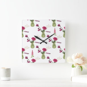 Exotisches Blumenarrangement im Glas Quadratische Wanduhr