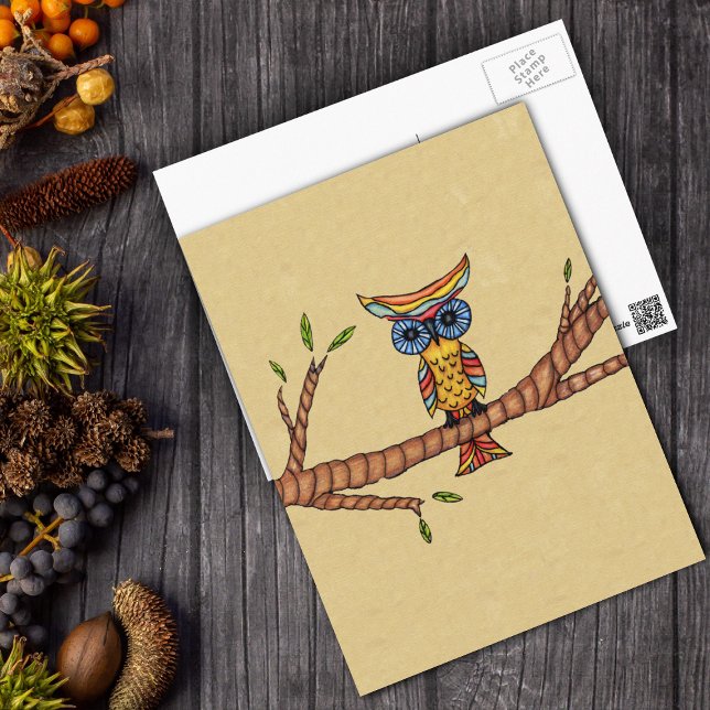 Extravagante Owlingzweig Postkarte (Fantasy colourful owl blue eyes sitting on tree branch on tan postcard.)