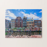 Fahrradhäuser am Canal de Amsterdam Niederlande Puzzle<br><div class="desc">Dieses atemberaubende City-Puzzle bietet Fahrräder entlang des Amsterdamer Kanals mit Gebäude im Hintergrund. #amsterdam #jigsawpuzzle #gift #stockingstuffe</div>