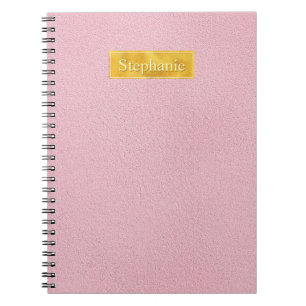 Falsche rosa Ledertextur mit Goldfolienbanner Notizblock