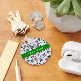 Farbenfrohe Blume, blauer Hintergrund, grün Schlüsselanhänger