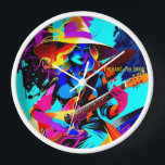 Farbenfrohe Pop Art Gitarrist Uhr<br><div class="desc">Das Bild zeigt eine Hexe, die eine E-Gitarre spielt und in einem lebendigen und bunten Kunststil dargestellt wird. Die Hexe trägt einen großen, breit gebrannten Hut und hat fließendes, gewelltes Haar in Gelb- und Blautönen. Ihr Ausdruck ist fokussiert und intensiv, während sie die Gitarre spielt, die sich durch ihre leuchtenden...</div>