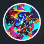 Farbenfrohe Pop Art Gitarrist Uhr<br><div class="desc">Das Bild zeigt eine Hexe, die eine E-Gitarre spielt und in einem lebendigen und bunten Kunststil dargestellt wird. Die Hexe trägt einen großen, breit gebrannten Hut und hat fließendes, gewelltes Haar in Gelb- und Blautönen. Ihr Ausdruck ist fokussiert und intensiv, während sie die Gitarre spielt, die sich durch ihre leuchtenden...</div>