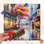 Farbenfroher Regentag im Wasserfarbenpuzzle der St Puzzle<br><div class="desc">Puzzle mit einem Aquarell-Gemälde eines Mädchens mit einem Regenschirm,  das an einem regnerischen Tag in der Blume vorbeigeht.</div>