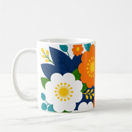 Farbige Blumenkunst mit orangefarbenen und weißen Kaffeetasse