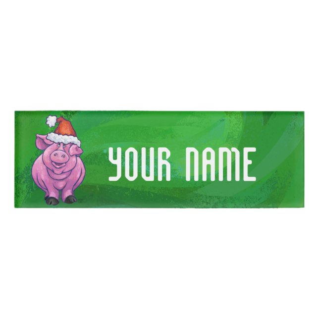 Feierliches Schwein in Weihnachtsmannmütze auf Grü Namenschild (Vorderseite)