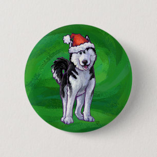 Feiernder Husky in Weihnachtsmannmütze auf Green Button
