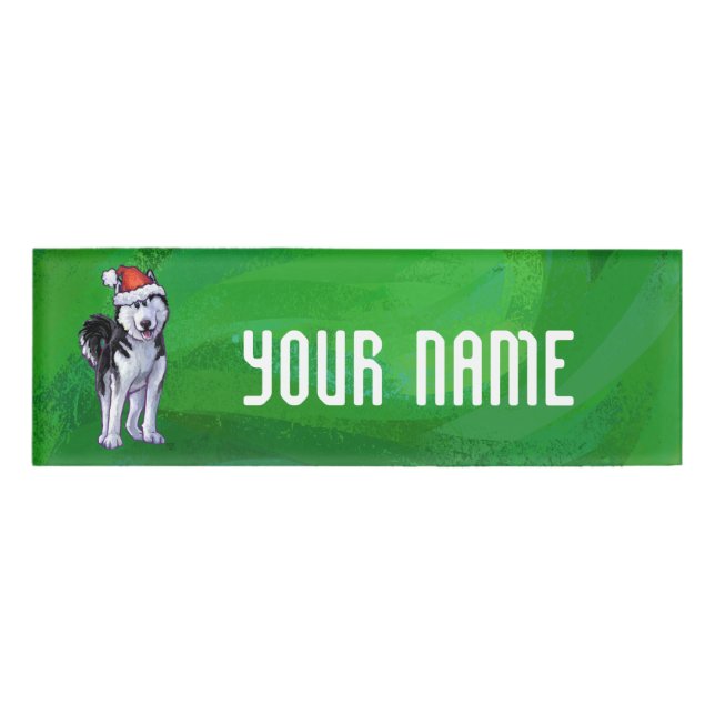 Feiernder Husky in Weihnachtsmannmütze auf Green Namenschild (Vorderseite)