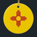 Flag New Mexico (US-Staat) Keramik Ornament<br><div class="desc">Dieses Design zeigt die Fahne des Staat von New Mexico, das sich in der südwestlichen Region der Vereinigten Staaten befindet. Die Fahne besteht aus einer stylisierten roten Sonne, ein Symbol, das von den indigenen Zia-Menschen verwendet wird, auf einem gelben Feld. Es wurde 1925 offiziell eingeführt, nachdem es 1920 entworfen wurde,...</div>