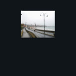 Foggy Morning at Scarborough Leinwanddruck<br><div class="desc">An atmospheric and moody scene of South Bay Beach in Scarborough, North Yorkshire, enveloped in a dense morning fog. Gentle waves lap at the sandy shore in the foreground, creating a foamy edge. The mist partially obscures the vibrant lights of the town and harbor, giving Scarborough a mysterious and ethereal...</div>