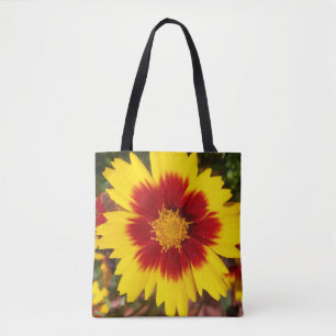 Foto einer gelben und roten Coreopsis-Blume auf