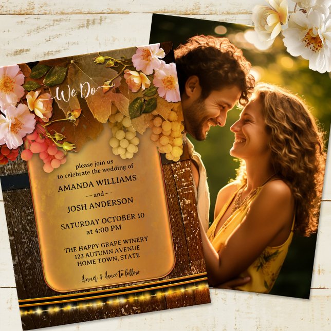 Foto Hochzeit von Wine Themed Lights Einladung (Wedding invitation featuring grapes and roses on a rustic wood wine barrel on gold and string lights)