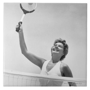 Frau, die Tennis 2 spielt Fliese