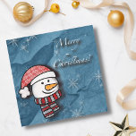 Frohe Weihnachten, Schneemann mit Strickkleidung<br><div class="desc">Ein schöner kleiner Schneemann mit weißer und roter Strickkleidung auf einem blauen Papier. Ideal,  um den Kleinen frohe Weihnachten zu wünschen.</div>