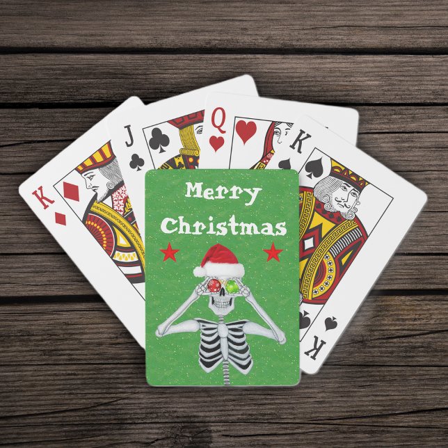 Frohe Weihnachten Skeleton Ornaments Sterne Weihna Spielkarten (Merry Christmas silly skeleton ornament eyes  red stars on green deck of playing cards.)