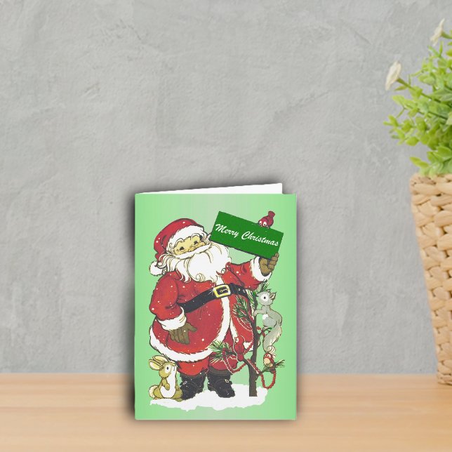 Frohe Weihnachten Weihnachtsmann Tiere Bäume Schne (cute Santa with little animals around decorated tree in snow on green Merry Christmas greeting card.)