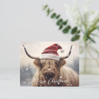Frohe Weihnachtskuh in einer Weihnachtsmannmütze H Feiertagspostkarte
