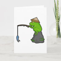 Frosch auf Stein beim Angeln mit Angelrute und Fis