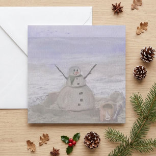 Frostiger Schneemann am Strand Feiertagskarte