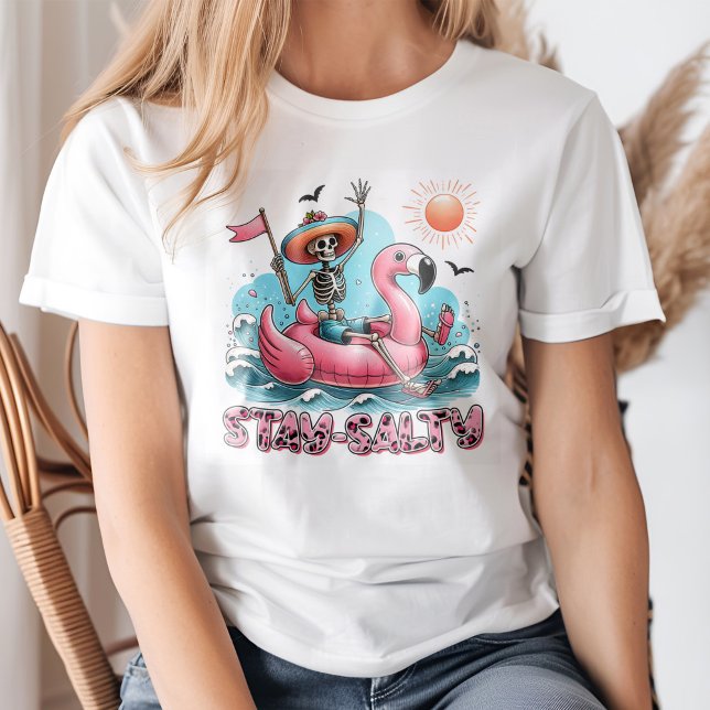 Funny Skeleton "Bleibe Salty" Summer Beach T-Shirt (Young blond woman wearing a Funny Skeleton "Stay Salty" Summer Beach T-Shirt)