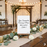 Funny "You Survived the Ceremony" Minimalist Weddi Tischnummer<br><div class="desc">Add a touch of humor to your wedding reception with this witty table number card! Featuring the playful phrase "You Survived the Ceremony! Please take a seat at, " this minimalist design uses elegant black script calligraphy on a crisp white background. It's the perfect icebreaker for your guests. Easily personalize...</div>