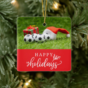 Fußball-Happy Holidays mit Ball auf grünem Gras Keramikornament