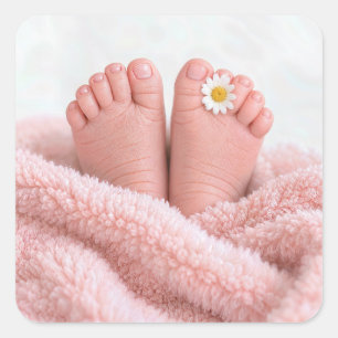 Füße eines Babymädchens mit einer weißen Margerite Quadratischer Aufkleber