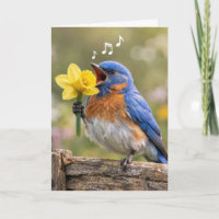 Geburtstagsblaue Vogel singt in eine gelbe Daffodi
