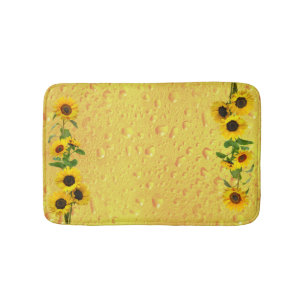 Gelbe Sonnenblumen mit Regentropfen auf Glas Badematte