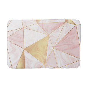 geometrische Dreiecke aus rosa und goldfarbenem Ma Badematte