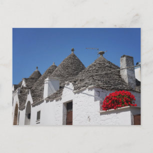 Geranium-Blume und Trulli-Häuser in Alberobello Postkarte