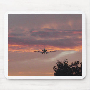 Gewerblicher Jet landet bei Sonnenuntergang Mousepad
