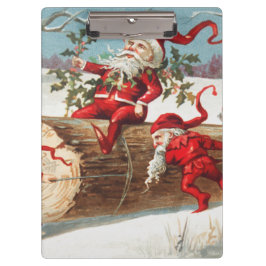 Gnomes dragging a cut tree trunk through the snow klemmbrett