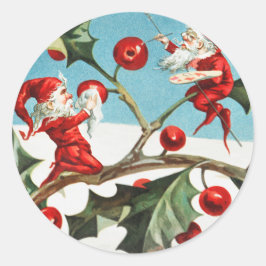 Gnomes painting holly berries in the snow runder aufkleber