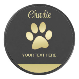 Gold Shiny Dog Paw auf schwarzem Hintergrund Eishockey Puck