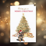 Gold Tree German Shepherd Welppy Christmas Card Feiertagskarte<br><div class="desc">Auf der Vorderseite dieser Weihnachtskarte trägt ein bezaubernder Hundewelpen der Deutschen Schäferhirte eine rot-weiße Weihnachtsmannmütze und sitzt vor einem Holiday Baum. Der Baum ist in Gold dekoriert, und passende Geschenkpakete sind darunter. Der rote und goldene Text sagt "Wünscht euch ein NUR CHRISTMAS". In Textfeldern, die Sie nach Belieben anpassen können....</div>