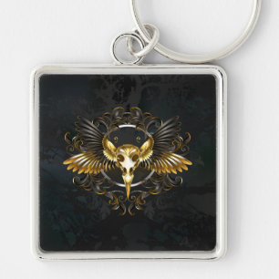 Golden Bird Skull auf schwarzem Hintergrund Schlüsselanhänger