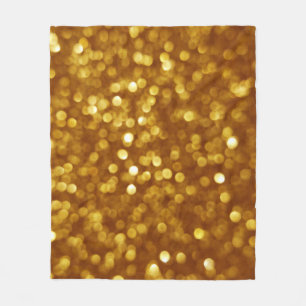Golden defokussierter Glitzer, funkelnde Textur. Fleecedecke