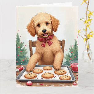 Golden Doodle beim Dekorieren von Weihnachtsplätzc Karte