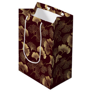 Goldene Ginkgoblätter auf roter eleganter Botanik Mittlere Geschenktüte