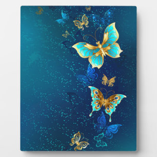 Goldene Schmetterlinge auf blauem Hintergrund Fotoplatte